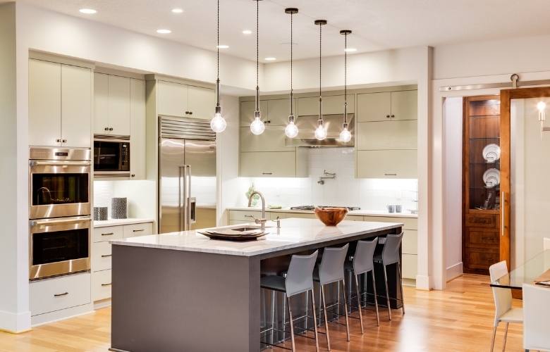 Kitchen ceiling lights over a marble kitchen island - Beautiful Homes