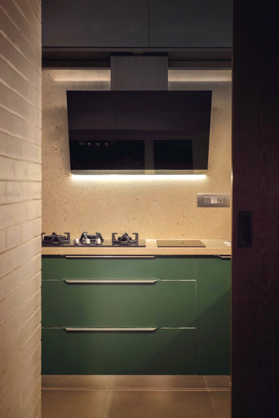 Mini kitchen with muted countertop and bright coloured cabinets