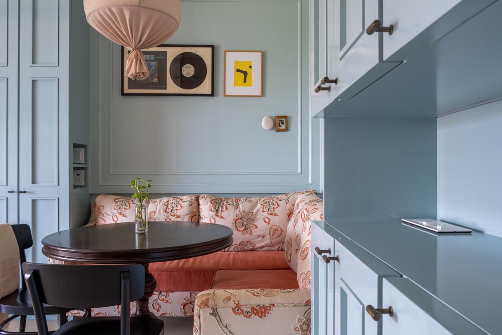 Spacious pastel blue modular kitchen having breakfast nook with round table - Beautiful Homes