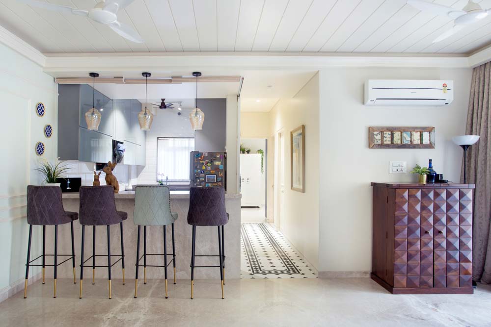 Semi-partition breakfast nook in this modular kitchen design with pendant lights - Beautiful Homes