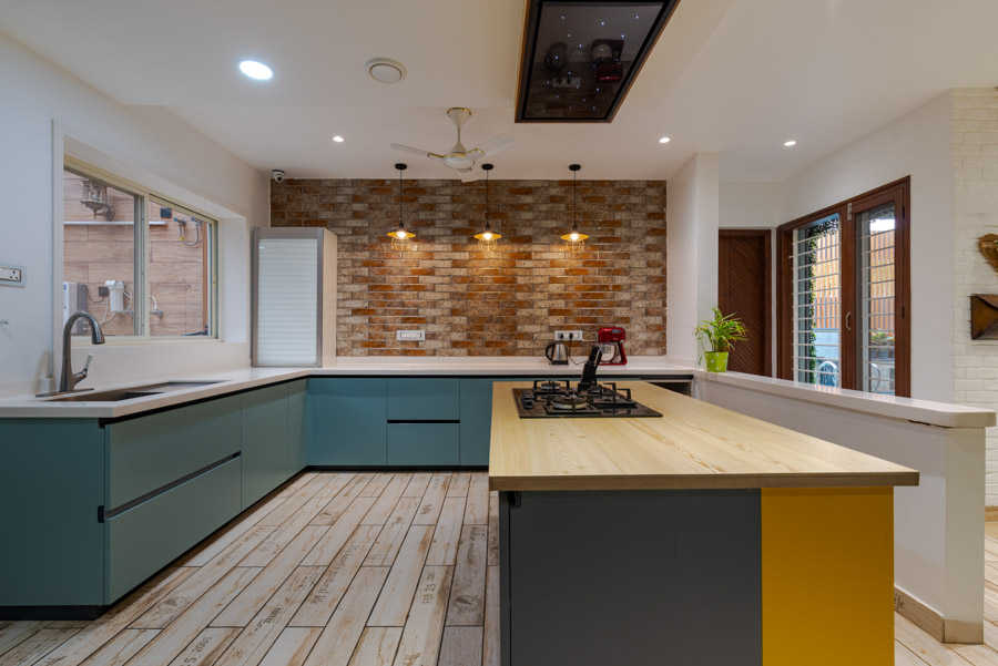 Urban kitchen design resembling a craft studio, cabinet in teal and white with island in light wood