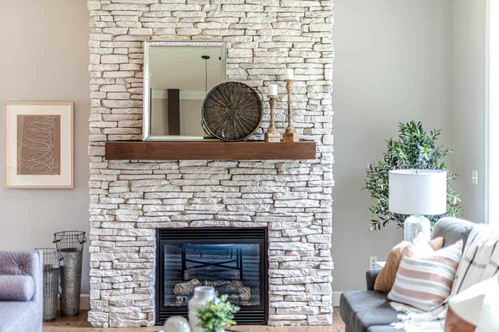 Give your stone fireplace an upgrade by repainting it for a refreshing look of your living room design - Beautiful Homes