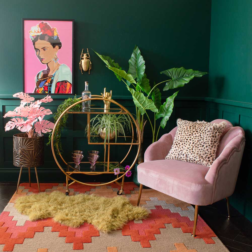 Green Living Room Corner With Pink Freida Kahlo Painting, Velvet Chair & Rug - Beautiful Homes