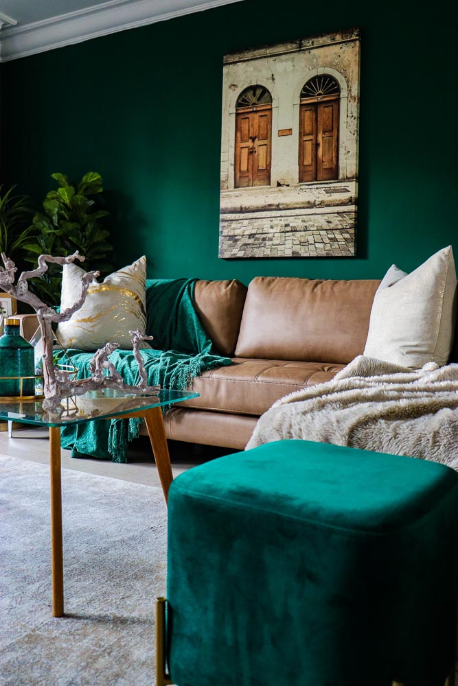 Green Living Room With Earthy Tones & Golden Accents, Brown Couch & Velvet Green Ottoman - Beautiful Homes