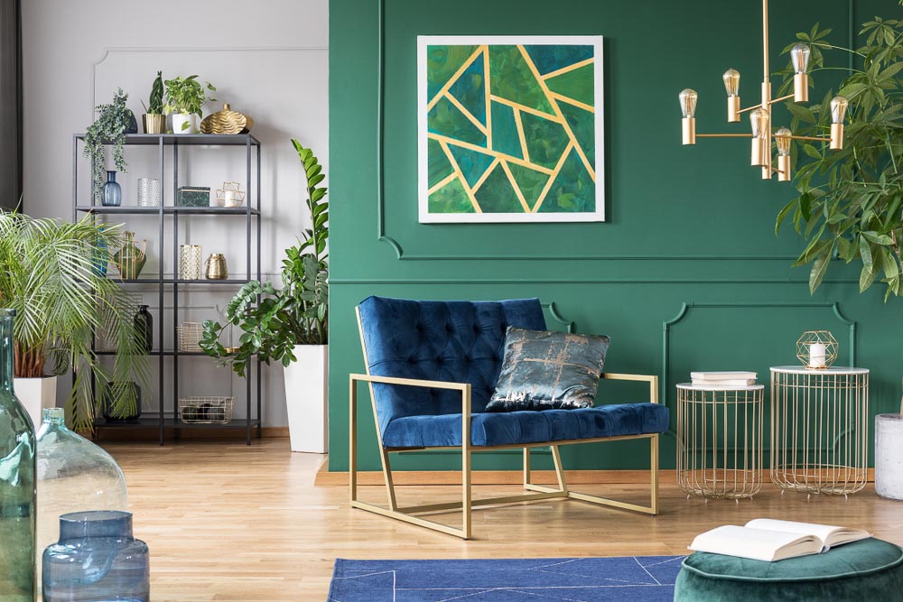 Green Living Room With Bold Shades Of Blue & Green, Touches Of Golden Metal On Lamp & Wall Art - Beautiful Homes