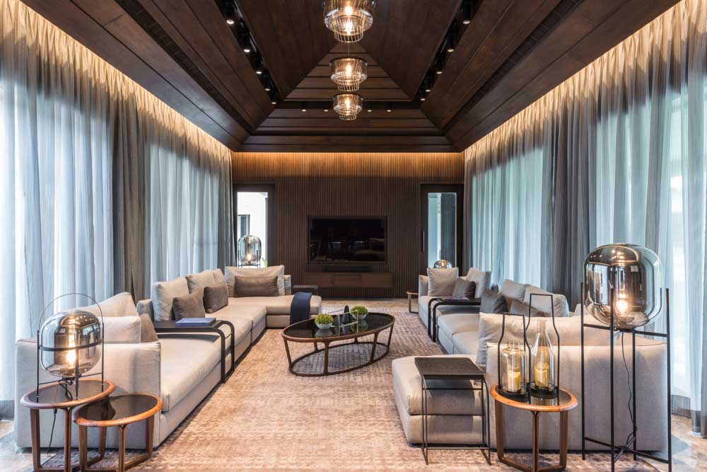 The console matches with the wood panelled wall in this living room design - Beautiful Homes