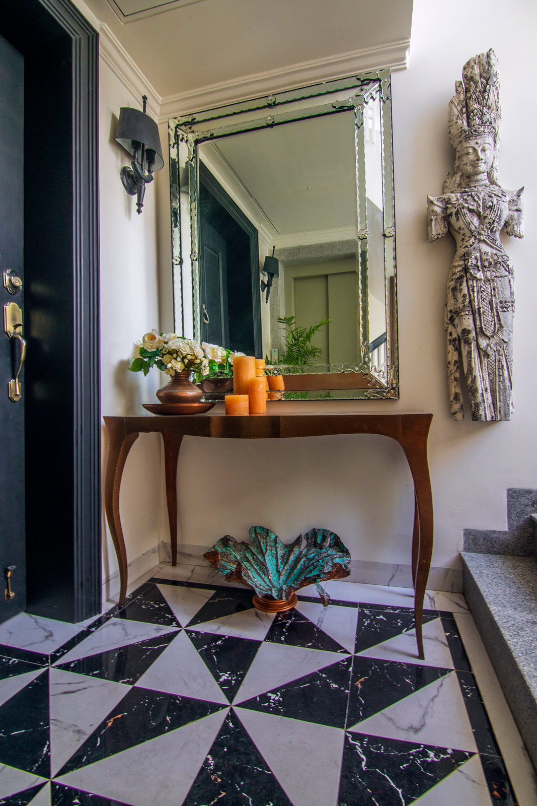 A sleek console paired with a statement mirror at the entryway - Beautiful Homes