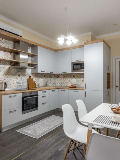 Hand knotted rug design in a L-shaped kitchen interior design - Beautiful Homes